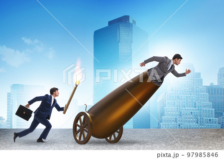 Concept of lay-off with businessman and cannon 97985846