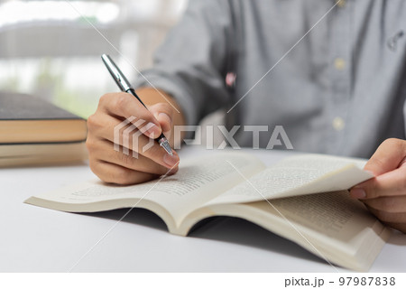 Businessperson reading and writing on book.education studying knowledge development and cognition learning concept. 97987838