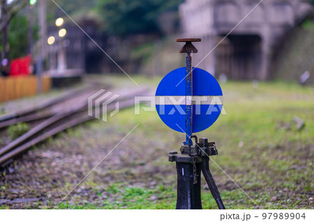 Blue and white manual track switch. It's next to the track. Blue and white manual track switch. It's next to the track. 97989904