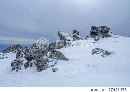Rocks on the top of Mount Alenga. Southern Demerdzhi in snow and ice in spring. Crimea 97991433