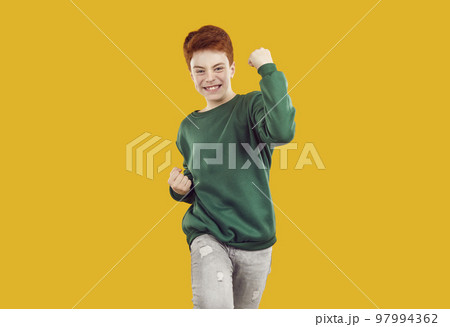 Happy standing isolated on orange background, celebrating success and doing yes gesture 97994362