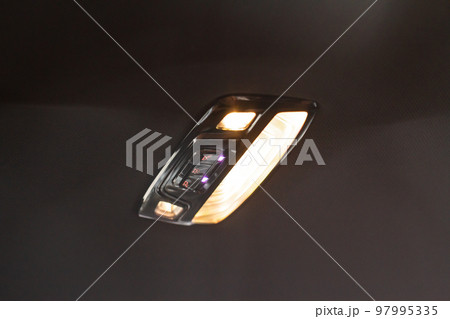 Car ceiling lamp in a car. Modern car interior lights close-up. Car ceiling lamp in a car. Modern car interior lights close-up. 97995335