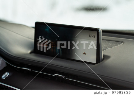 Modern car media display in the interior of the car. Touchscreen monitor on the dashboard of the modern car. 97995359