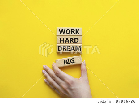 Work and dream symbol. Wooden blocks with words Work Hard Dream Big. Beautiful yellow background. Businessman hand. Business and Work Hard Dream Big concept. Copy space. Work and dream symbol. Wooden blocks with words Work Hard Dream Big. Beautiful yellow background. Businessman hand. Business and Work Hard Dream Big concept. Copy space. 97996736