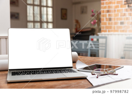 Laptop with tablet on architect desk. Business, architecture, building construction and technology concept. Laptop with tablet on architect desk. Business, architecture, building construction and technology concept. 97998782