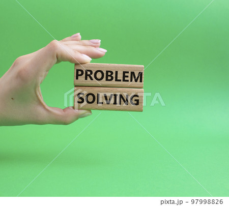 Problem solving symbol. Concept word Problem solving on wooden blocks. Beautiful green background. Businessman hand. Business and concept. Copy space Problem solving symbol. Concept word Problem solving on wooden blocks. Beautiful green background. Businessman hand. Business and concept. Copy space 97998826