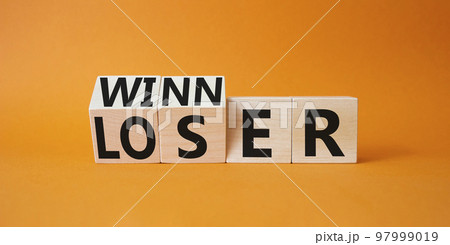 Winner and Loser symbol. Turned wooden cubes with words Winner and Loser. Beautiful orange background. Business and Winner and Loser concept. Copy space 97999019