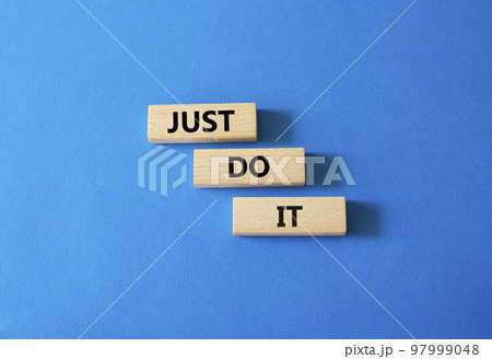 Just do it symbol. Wooden blocks with words Just do it. Beautiful blue background. Business and Just do it concept. Copy space. Just do it symbol. Wooden blocks with words Just do it. Beautiful blue background. Business and Just do it concept. Copy space. 97999048
