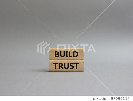 Build trust symbol. Wooden blocks with words Build trust. Beautiful grey background. Business and Build trust concept. Copy space. Build trust symbol. Wooden blocks with words Build trust. Beautiful grey background. Business and Build trust concept. Copy space. 97999114