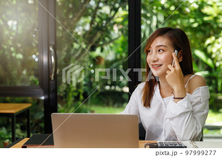 Portrait of a designer holding a pen and smile as she can come up with new ideas. 97999277