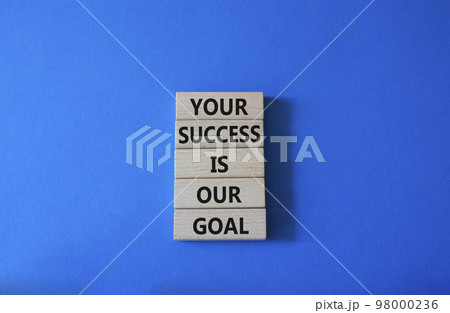 Your success is our goal symbol. Wooden blocks with words Your success is our goal. Beautiful blue background. Business and Your success is our goal concept. Copy space 98000236