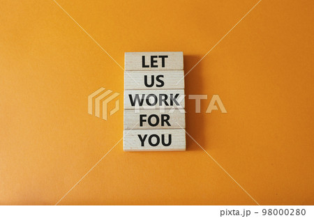 Let us work for you symbol. Wooden blocks with words Let us work for you. Beautiful orange background. Business and Let us work for you concept. Copy space. 98000280