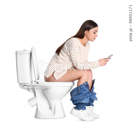 Woman with smartphone sitting on toilet bowl, white background 98001171