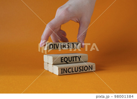 Diversity Equity Inclusion symbol. Concept words Diversity Equity Inclusion on wooden blocks. Beautiful orange background. Bisinessman hand. Business and Diversity Equity Inclusion concept. Copy space Diversity Equity Inclusion symbol. Concept words Diversity Equity Inclusion on wooden blocks. Beautiful orange background. Bisinessman hand. Business and Diversity Equity Inclusion concept. Copy space 98001384