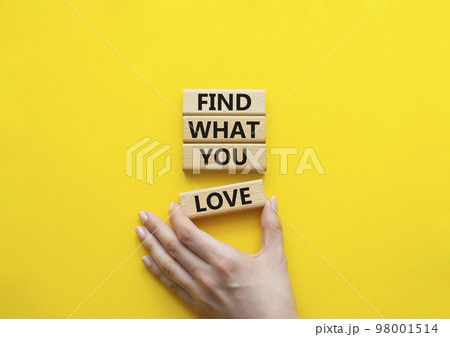 Find what you love symbol. Concept words Find what you love on wooden blocks. Beautiful yellow background. Businessman hand. Business and Find what you love concept. Copy space. 98001514