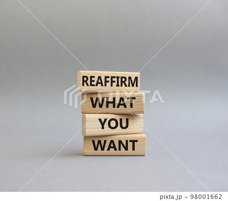 Goals symbol. Wooden blocks with words 'Reaffirm what you want'. Beautiful grey background. Business and 'Reaffirm what you want' concept. Copy space. Goals symbol. Wooden blocks with words 'Reaffirm what you want'. Beautiful grey background. Business and 'Reaffirm what you want' concept. Copy space. 98001662