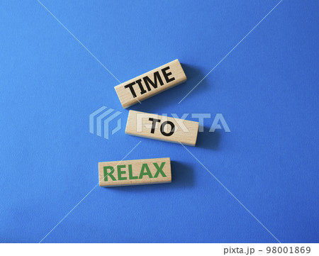 Time to relax symbol. Concept word Time to relax on wooden blocks. Beautiful blue background. Business and Time to relax concept. Copy space 98001869