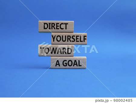 Direct yourself toward a goal symbol. Wooden blocks with words Direct yourself toward a goal. Beautiful blue background. Business and Direct yourself toward a goal concept. Copy space. Direct yourself toward a goal symbol. Wooden blocks with words Direct yourself toward a goal. Beautiful blue background. Business and Direct yourself toward a goal concept. Copy space. 98002485
