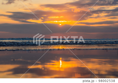 Sunset on the Kuta beach with reflection in the water on the island of Bali 98002538