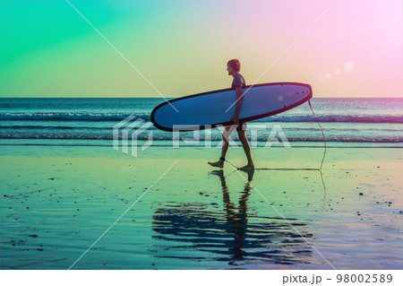 Vacation Silhouette Of A Surfer Carrying His Surf Board Home At Sunset With Copy Space Vacation Silhouette Of A Surfer Carrying His Surf Board Home At Sunset With Copy Space 98002589