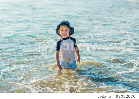 happy little boy running on sand tropical beach happy little boy running on sand tropical beach 98002970