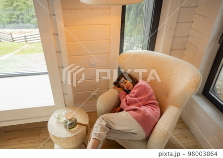 Woman sleeps at comfortable sofa in house Woman sleeps at comfortable sofa in house 98003864