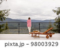 Woman rests on terrace in mountains 98003929