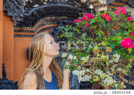 Young woman tourist on the background of Tanah Lot - Temple in the Ocean. Bali, Indonesia 98004298