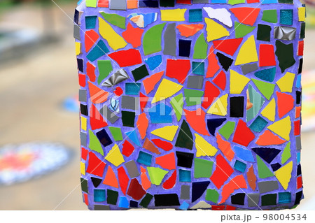 Colorful pattern ceramic tiles or mosaic. Detail of beautiful old collapsing abstract ceramic mosaic adorned building. Venetian mosaic as decorative background. Selective focus. 98004534