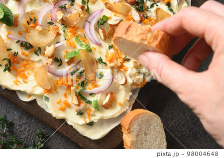 Butterboard with onion, garlic, orange, herbs and crispy baguette. Butterboard with onion, garlic, orange, herbs and crispy baguette. 98004648