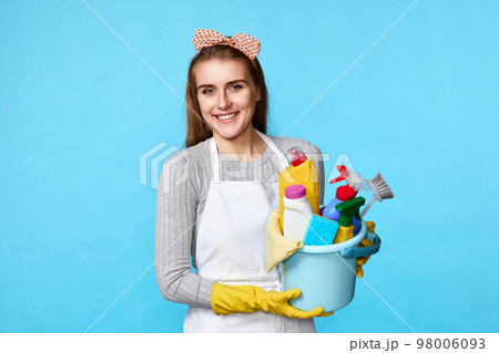 woman in gloves holding bucket with cleaning supplies 98006093