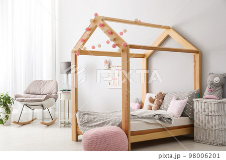 Stylish child room interior with comfortable bed 98006201