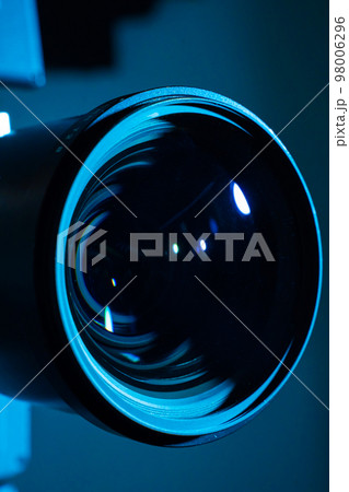 Close-up of a digital camera lens with dark light. Copy space for text vertical. Close-up of a digital camera lens with dark light. Copy space for text vertical. 98006296
