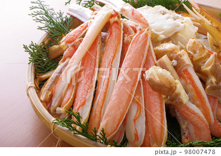 竹ザルに盛った、たくさんのカニ足 98007478