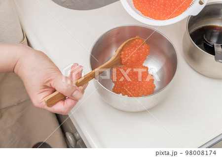 【イクラの醤油漬けを作るために、お酒が馴染んだ生イクラをボウルに移す】 【イクラの醤油漬けを作るために、お酒が馴染んだ生イクラをボウルに移す】 98008174