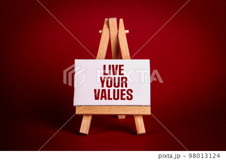 Live your values. Miniature easel with text on a red background Live your values. Miniature easel with text on a red background 98013124