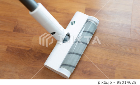 Woman vacuuming the floor of her living room, Big cleaning in the house, Removes germs and dirt and deep stains, Housewife cleaning, Keeping her home clean, Domestic hygiene. Woman vacuuming the floor of her living room, Big cleaning in the house, Removes germs and dirt and deep stains, Housewife cleaning, Keeping her home clean, Domestic hygiene. 98014628