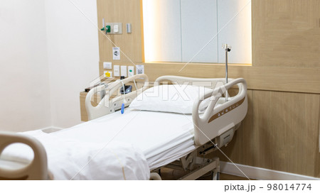 Modern Adjustable Patient Bed in Hospital, Patient admission room background image, Clean and germ-free recovery room, Service point in a modern hospital, Nursing room, Hospital or clinic. Modern Adjustable Patient Bed in Hospital, Patient admission room background image, Clean and germ-free recovery room, Service point in a modern hospital, Nursing room, Hospital or clinic. 98014774