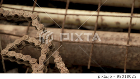 Scrap metal for recycling background. a lot of different rusty industrial part detail for melt and reused. Old rusty metal surface. Abstract background for design purpose. Warm orange color. Random Scrap metal for recycling background. a lot of different rusty industrial part detail for melt and reused. Old rusty metal surface. Abstract background for design purpose. Warm orange color. Random 98018025