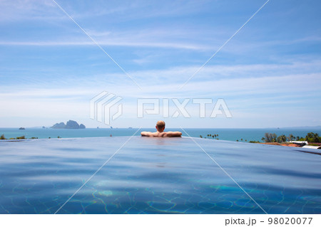 Male Resting In Infinity Pool At Aonang Cliff Beach Resort Male Resting In Infinity Pool At Aonang Cliff Beach Resort 98020077