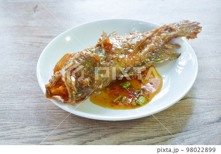 batter fried red grouper fish dressing sweet and spicy chili sauce on plate batter fried red grouper fish dressing sweet and spicy chili sauce on plate 98022899