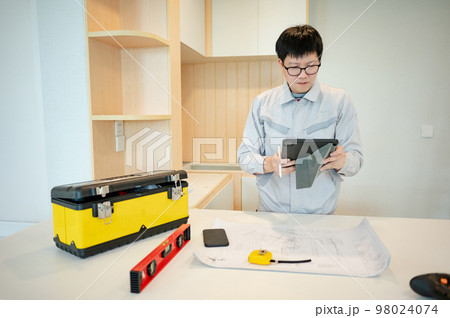 Interior manual worker working with construction tools Interior manual worker working with construction tools 98024074