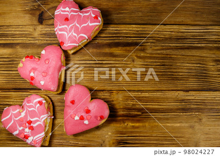 Heart shaped cookies on wooden table. Top view, copy space. Dessert for Valentine day Heart shaped cookies on wooden table. Top view, copy space. Dessert for Valentine day 98024227