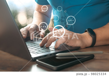 hands on keyboard laptop and virtual message icons. Live chat chatting and social network concepts, Close-up hands typing on keyboard laptop with virtual massage icons 98025334