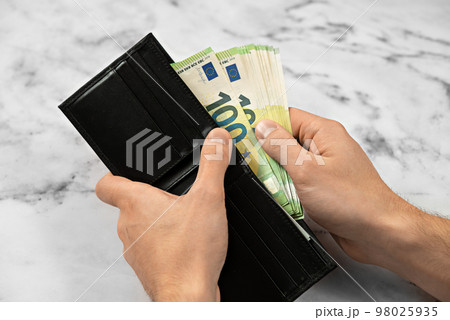 banknote money in a wallet on a light background, the concept of saving money and business growth banknote money in a wallet on a light background, the concept of saving money and business growth 98025935
