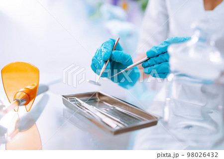 A set of sterile dental instruments for dental treatment. Dental care for people. 98026432