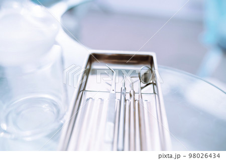 A set of sterile dental instruments for dental treatment. Dental care for people. A set of sterile dental instruments for dental treatment. Dental care for people. 98026434