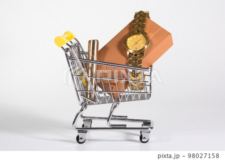 A golden watch in a shopping cart at the white background. Presents, purchases A golden watch in a shopping cart at the white background. Presents, purchases 98027158