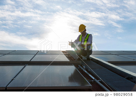 Engineer working setup Solar panel at the roof top.  98029058
