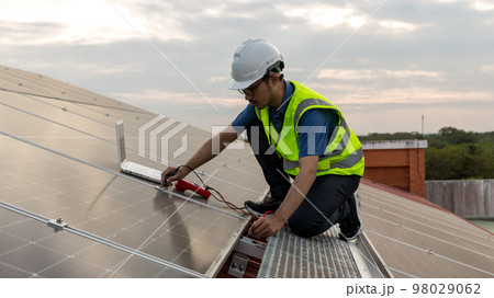 Engineer working setup Solar panel at the roof top.  98029062